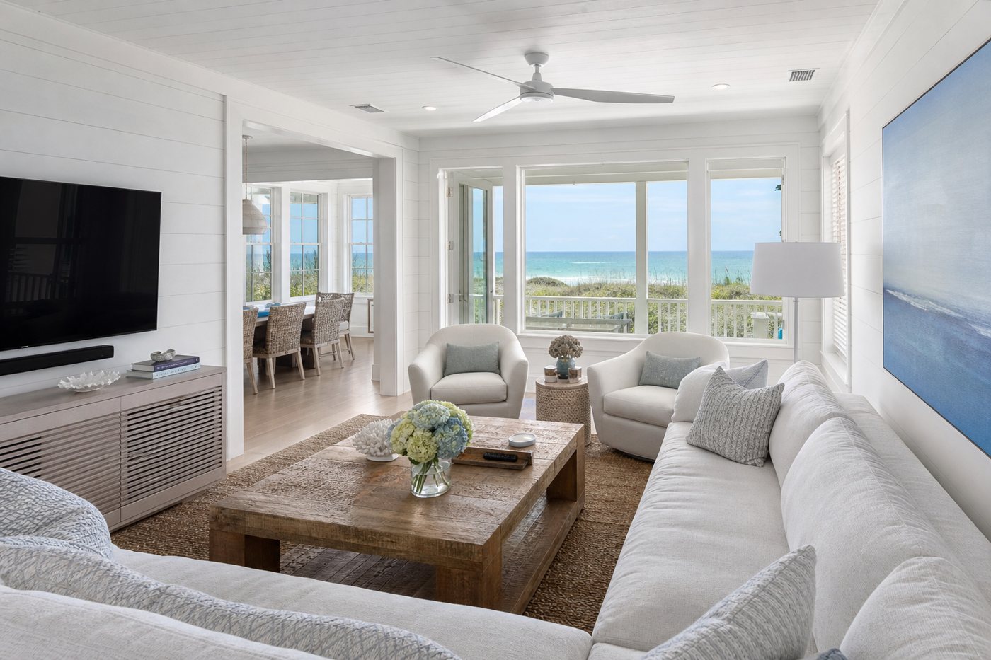 Bright coastal living room with a Gulf-front view, representative of the area's beach homes